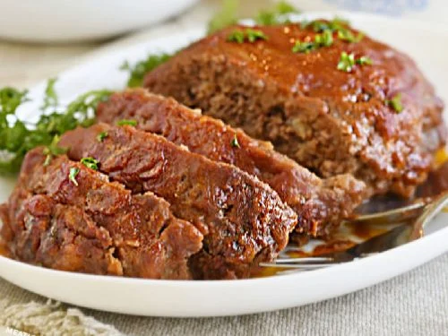 Meatloaf served in a white plate for tradition.