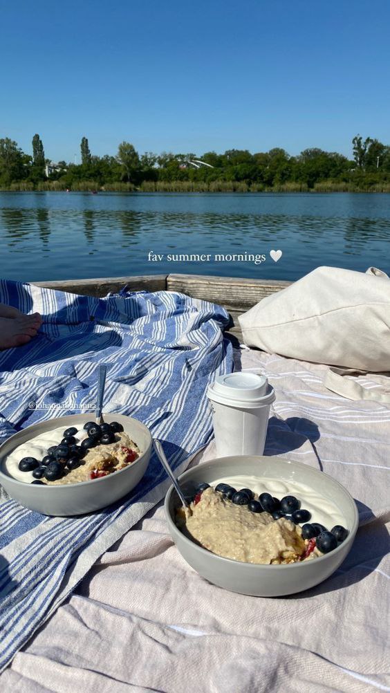 Two bowls of oatmeal, blueberry, yogurt, and milk for a summer morning boat trip.