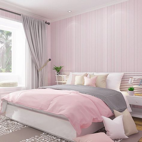 Bed with warm, inviting wallpaper