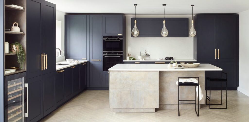 A beautifully renovated kitchen consisting of white marble countertops, white subway tile backsplash, and all the hardware and accessories to balance the look.