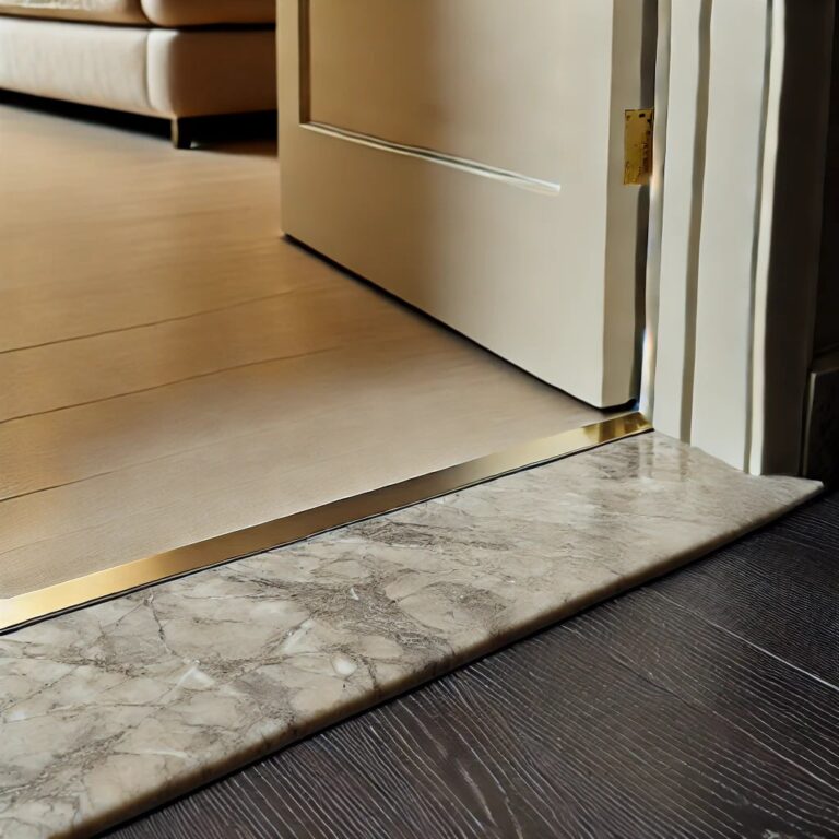 Detailed image of a beige marble door threshold, featuring fine gray and white veins. The glossy finish catches soft lighting, creating a luxurious contrast against the dark wood flooring of a contemporary hallway.