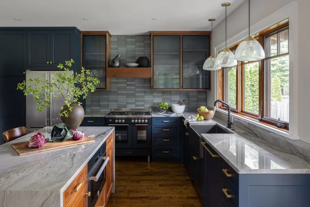 The picture serves as a tip to anyone who wants to create a different look with their dark blue cabinets. It consists of unique lighting that pairs with lighter elements, the right hardware, and a touch of embracing boldness.